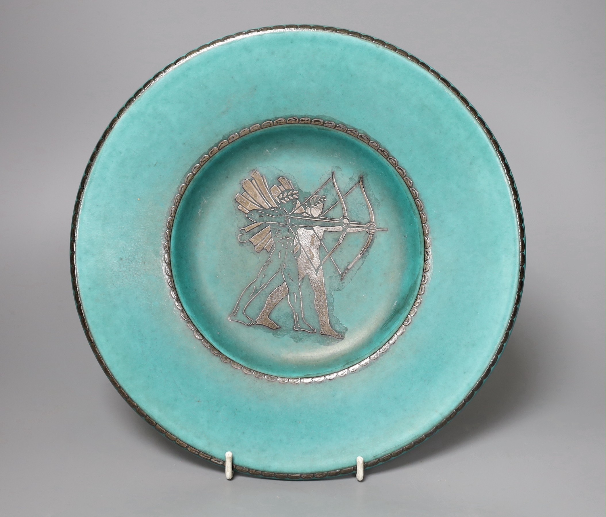 A Gustavsberg Wilhelm Kåge design Argenta 909 shape dish decorated with archers, 26cm diameter